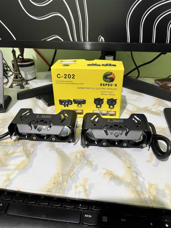 High-performance electric motorcycle foot pegs displayed on a marble surface with a yellow Spec's box in the background, highlighting innovative ride India Ride electric vehicle accessories.