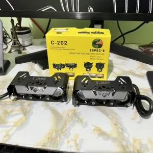 High-performance electric motorcycle foot pegs displayed on a marble surface with a yellow Spec's box in the background, highlighting innovative ride India Ride electric vehicle accessories.